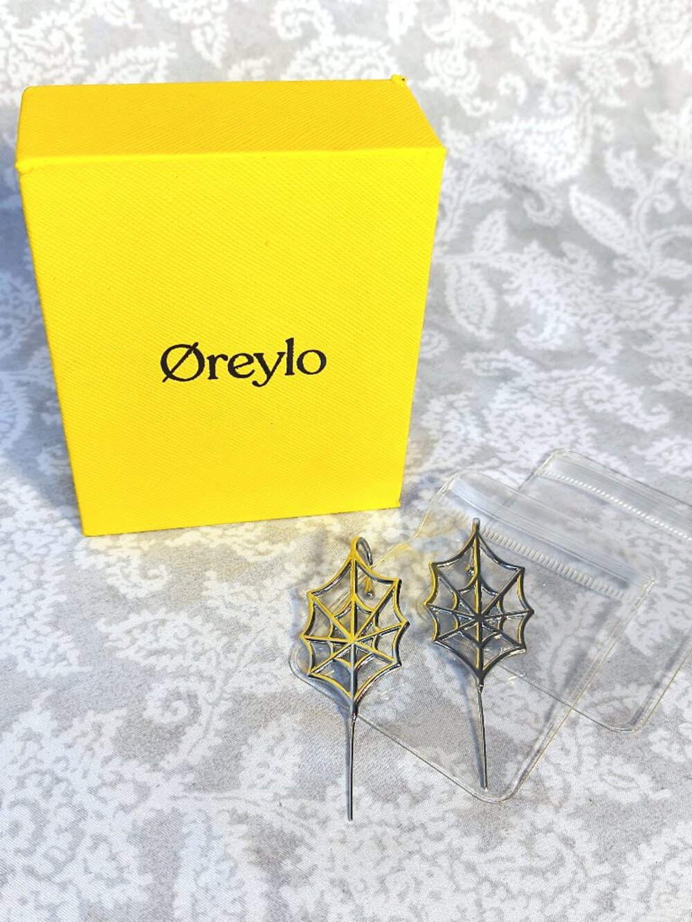 Oreylo brand earrings feature a unique spiderweb design silver tone - Worn once